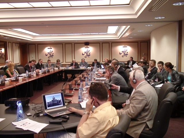 Moscow Economist Club session — senior business and government figures around a boardroom table