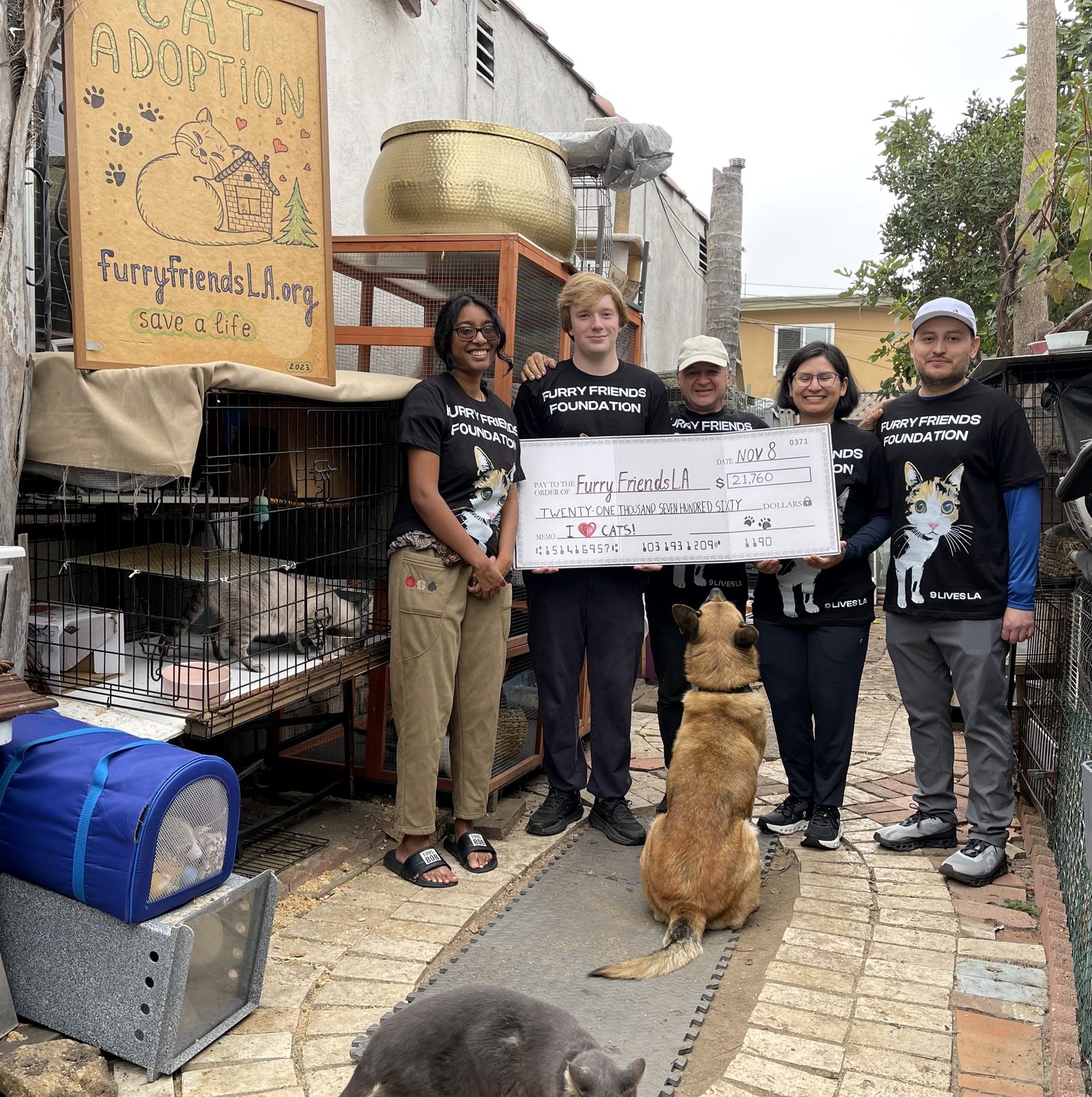 Furry Friends Foundation volunteer team holding a $21,760 donation check
