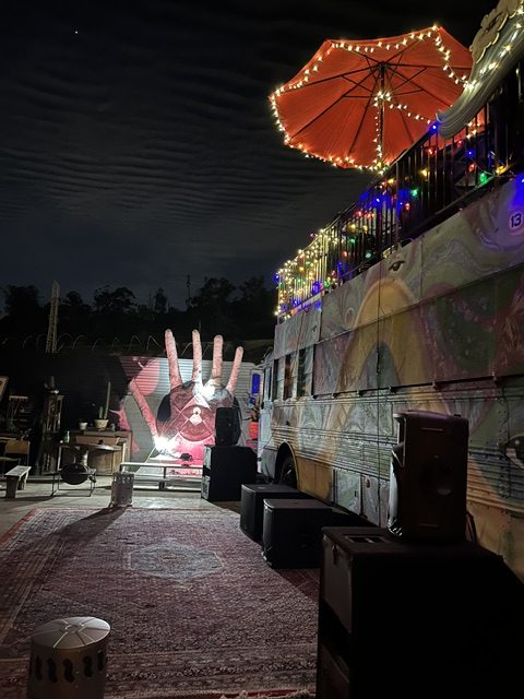 Kitty Bus rooftop deck at night with umbrella and string lights