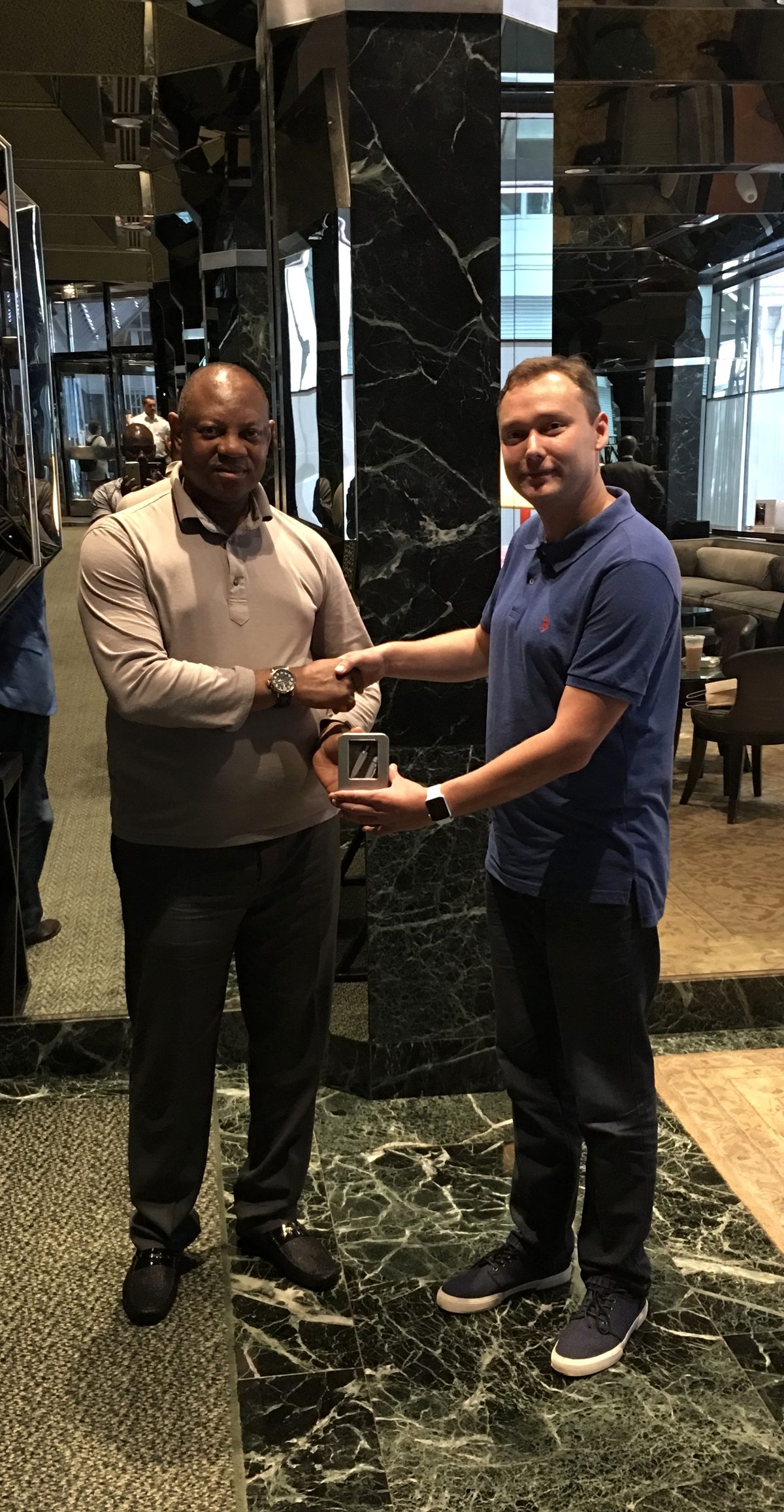 Arseny receiving a token of appreciation from Brigadier General Paul T. Boroh (Retired), Special Adviser to the President of Nigeria